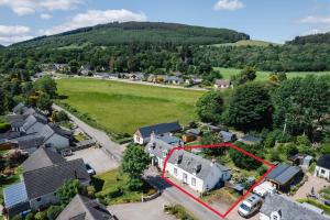 an aerial view of a small village with a red line at Traditional Highland Cottage Near Loch Ness in Drumnadrochit
