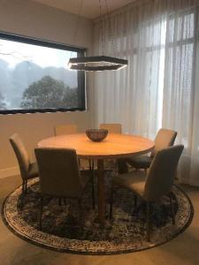 a dining room table with chairs and a bowl on it at Konayuki Penthouse 9 in Falls Creek +5 photos