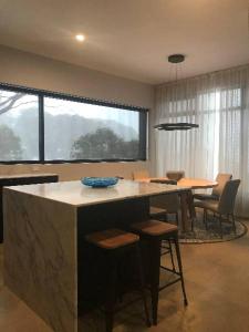 a kitchen with a large island with a table and chairs at Konayuki Penthouse 9 in Falls Creek