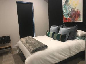 a bedroom with a large white bed with pillows at Konayuki Penthouse 9 in Falls Creek