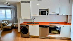 a kitchen with a stove and a sink and a dishwasher at Explore Tarazona from This Central & Peaceful Flat in Tarazona de Aragón