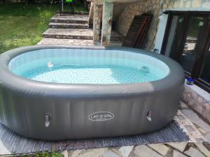 a large circular hot tub in a yard at The Byala Escape, Private Villa with Bar & Hot Tub in Byala