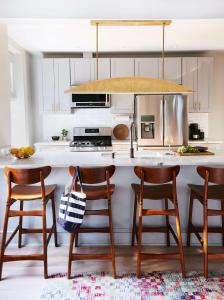 a kitchen with a kitchen island with four chairs at Luxury King Suite Full Kitchen 3rd Floor in Savannah