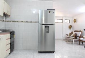 a stainless steel refrigerator in a kitchen at Grande & Centro Apartamento Privado in Santa Marta