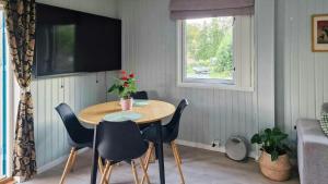 a dining room with a table and chairs and a window at Charming Seaside Cabin In Tingvoll in Tingvoll