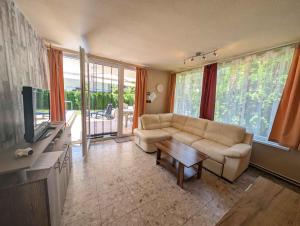 a living room with a couch and a table at Holiday home in Siofok - Balaton 53215 in Siófok