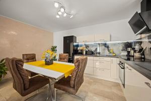 a kitchen with a yellow table and chairs in a kitchen at Family friendly house with a swimming pool Rovinj - 24669 in Rovinj