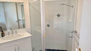 a bathroom with a sink and a shower at Milo's at the Bay by Experience Jervis Bay in Vincentia +13 photos