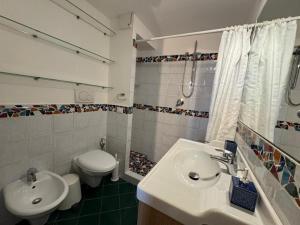 a bathroom with a sink and a toilet at Appartamento Selene in Monopoli +44 photos