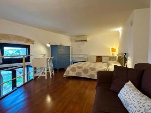 a living room with a bed and a couch at Appartamento Selene in Monopoli