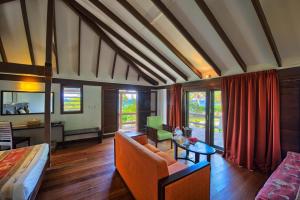 a living room with a couch and a table at Mana Island Resort & Spa - Fiji in Mana Island