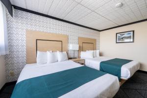 a hotel room with two beds in a room at Sternwheeler Hotel & Conference Centre, Trademark by Wyndham in Whitehorse +35 photos