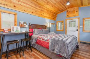 a bedroom with a bed and a desk in a room at Acorn Cottage at Hocking Vacations in Logan