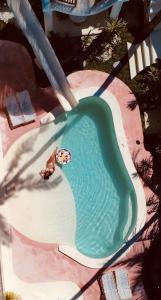 a person on a slide in a swimming pool at ALMA BONITA walking distance to the beach in Gili Air