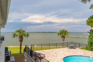 a patio with a view of the water at Wolf Bay Villas in Orange Beach