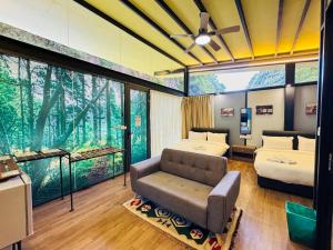 a bedroom with two beds and a couch and a fish tank at Xscape Tambun in Ipoh