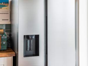 a silver refrigerator with a coffee maker on it at Two Seas Hebrides in Eoropie +34 photos