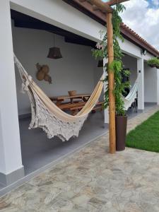 a hammock on the patio of a house at Villa Chalés in Piranhas