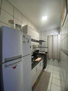 a kitchen with a refrigerator and a stove at Apartamento frente a praia Santos in Santos
