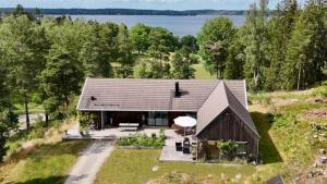 an overhead view of a house with a lake in the background at Your Archipelago Dream On Ingarö in Värmdö