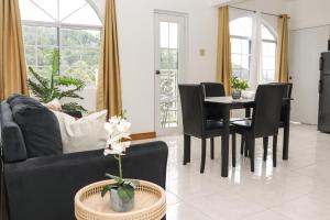 a living room with a black couch and a table at Lagoon View Estates in Montego Bay