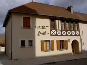 a white building with a hotel ranger sign on it at Hôtel Losset in Flagey-Échézeaux