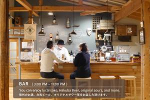 a group of people sitting at a counter at Lodge Free Run in Otari
