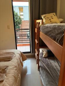 Ένα ή περισσότερα κρεβάτια σε δωμάτιο στο Departamento Confortable en Santiago