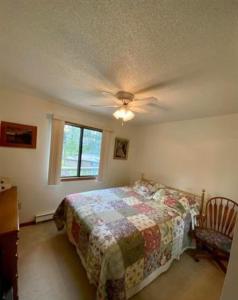 a bedroom with a bed and a ceiling fan at Sandy Lake Lodge in Toivola