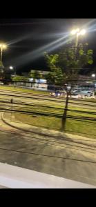 a blurry picture of a street at night with a tree at casa km in Rio das Ostras