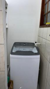 a toilet in the corner of a bathroom at casa km in Rio das Ostras