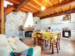 a kitchen and a dining room with a table and a fireplace at Belvilla by OYO Farmhouse with Private Terrace in Bagni di Lucca +19 photos