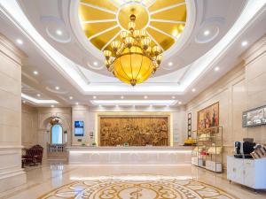 长沙Vienna International Hotel Changsha BBK Meixi Xintiandi Branch的宽敞的大堂，天花板上有一盏大吊灯