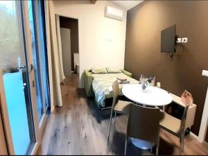 a room with a bed and a table and a sink at Apartment in Iseo with Pool in Cazzago San Martino