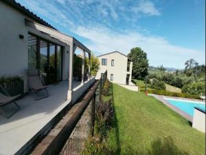 a house with a view of a swimming pool at Apartment in Iseo with Pool in Cazzago San Martino