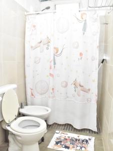 a bathroom with a toilet and a shower curtain at Departamento en Planta baja, centrico, Practico, Estacionamiento D4 in San Fernando del Valle de Catamarca +19 photos
