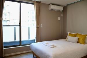Een bed of bedden in een kamer bij New open 岸里玉出 Maison Le Jaune 玉子心斋桥道顿崛电车直达
