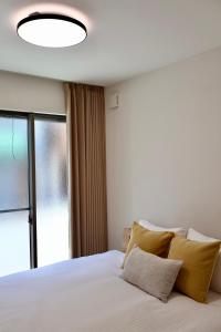 Een bed of bedden in een kamer bij New open 岸里玉出 Maison Le Jaune 玉子心斋桥道顿崛电车直达