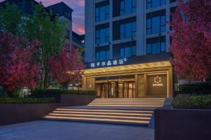 a building with stairs in front of it at Orange Crystal Beijing Capital Airport New International Exhibition Hotel in Beijing