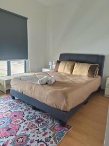 a bed in a bedroom with two pillows and a rug at Sweet Escape at Splashmania in Banting +22 photos