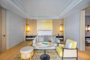 a bedroom with a bed and a living room at InterContinental Phuket Resort by IHG in Kamala Beach