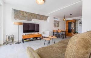 a living room with a couch and a tv at 2 Bedroom Amazing Apartment In Portoroz in Portorož