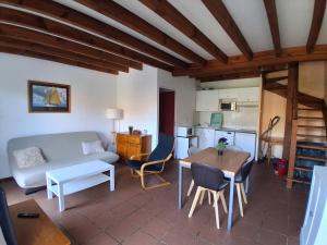 a living room with a couch and a table at Villa patio avec piscine, à 400m des commerces et 6km de plage - Animaux admis - FR-1-239-83 in Seignosse