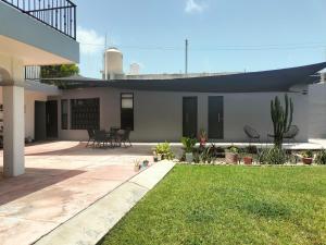 a house with a patio and a yard at Stella by Türk in Chetumal