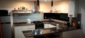 a kitchen with black and white counter tops at Funes Inn in Funes