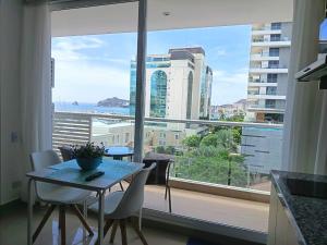 a kitchen with a table and a large window at Luxurious Apartment with Ocean View in Santa Marta