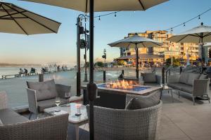 a patio with a fire pit with chairs and umbrellas at You Deserve the Best! in Tacoma