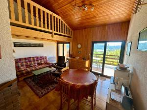 a living room with a couch and a table at Appartement T4 Duplex 60m², 6 Pers, Vue Lac & Montagnes - FR-1-758-40 in Les Angles