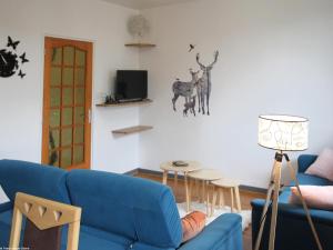 a living room with a blue couch and a table at Appartement rénové 3 chambres à Luxeuil-les-Bains - FR-1-583-398 in Luxeuil-les-Bains