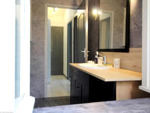 a bathroom with a sink and a mirror at Appartement rénové 3 chambres à Luxeuil-les-Bains - FR-1-583-398 in Luxeuil-les-Bains +8 photos